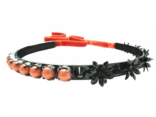 Jasmine choker in a beautiful hematite finish, embellished with flowers, spikes and coral Swarovski pearls. Fastest at the back with a luxurious velvet ribbon in a vibrant orange.  