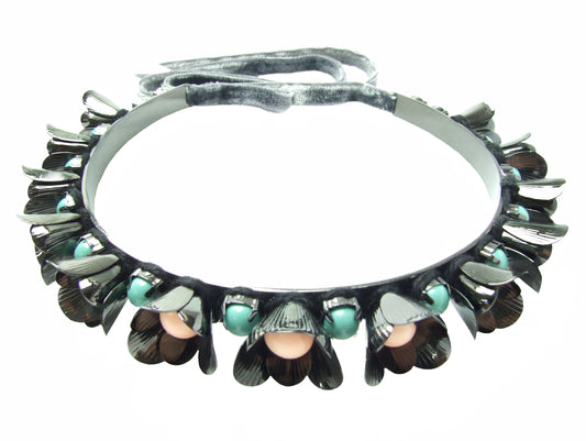 With beautiful dark finish in hematite, metal Lilly choker is embellished with flowers and pastel coloured Swarovski pearls. The choker fastens at the back with a luxurious velvet ribbon. 